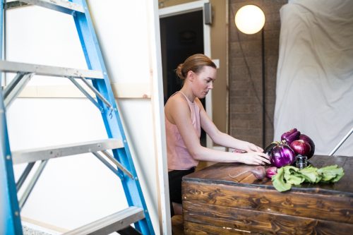 Madalyn arranging food for a photoshoot. Photo by FYT Productions